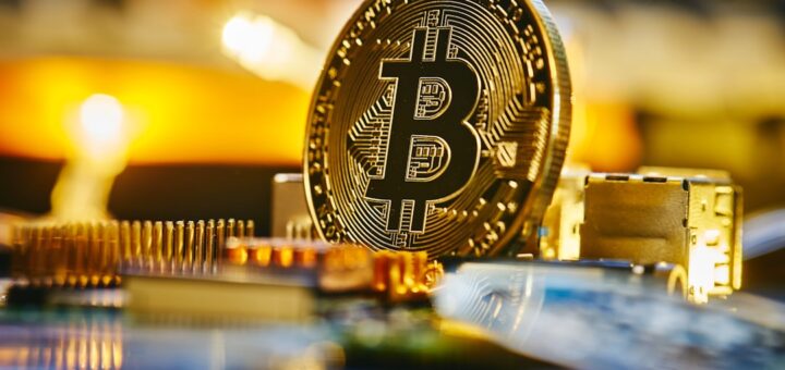 a bitcoin sitting on top of a computer chip