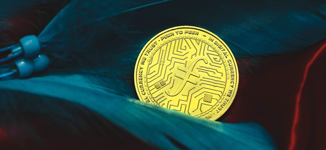 a bit coin sitting on top of a feather