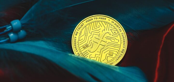 a bit coin sitting on top of a feather