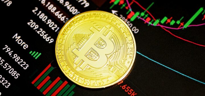 gold round coin on black surface