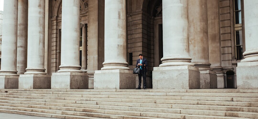 man standing in the middle of pillar building