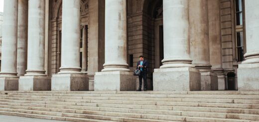 man standing in the middle of pillar building