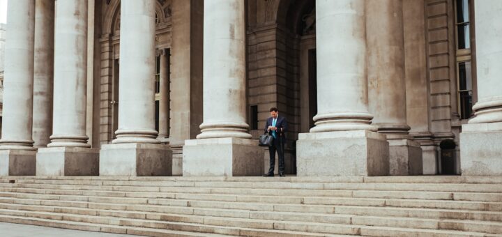 man standing in the middle of pillar building