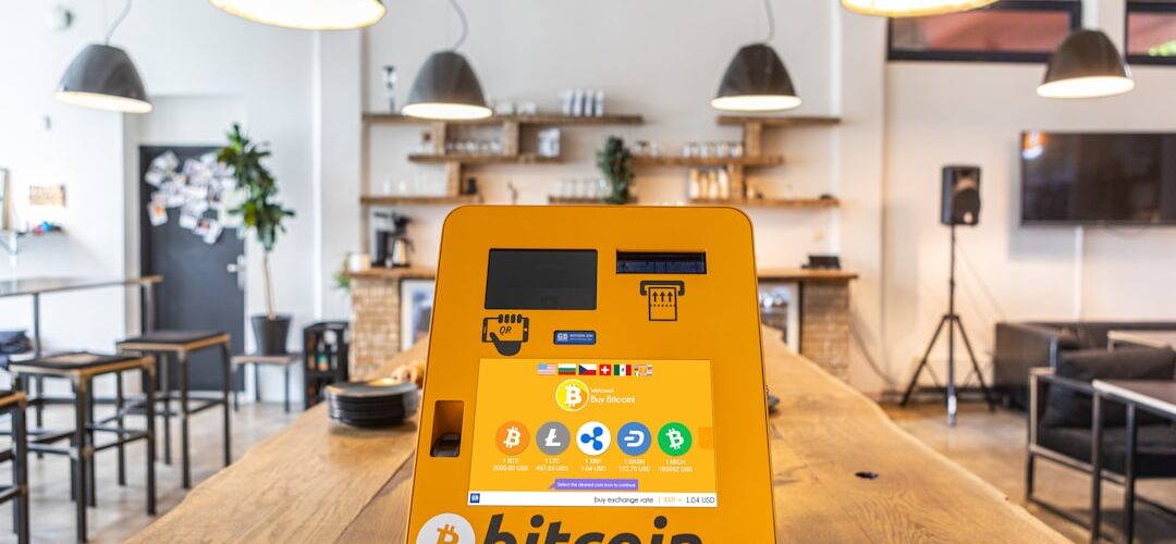 a bitcoin atm sitting on top of a wooden table