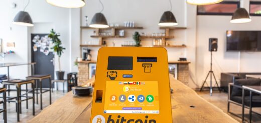 a bitcoin atm sitting on top of a wooden table