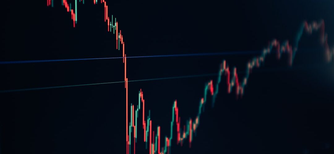 candlestick stock chart on dark screen