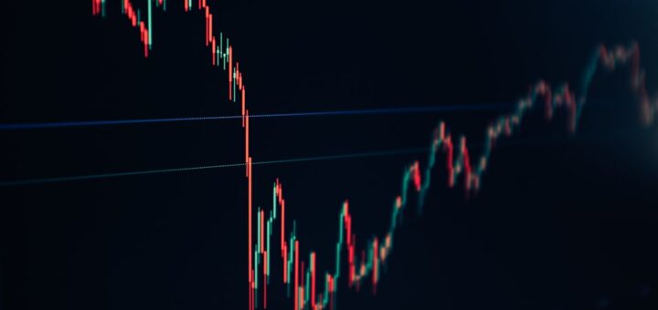 candlestick stock chart on dark screen