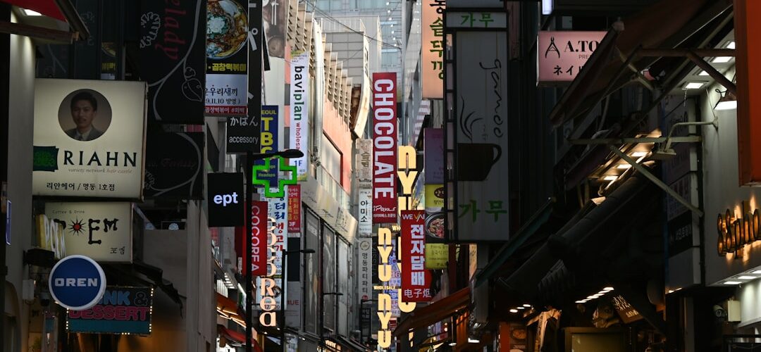 A busy street lined with illuminated signs at night.