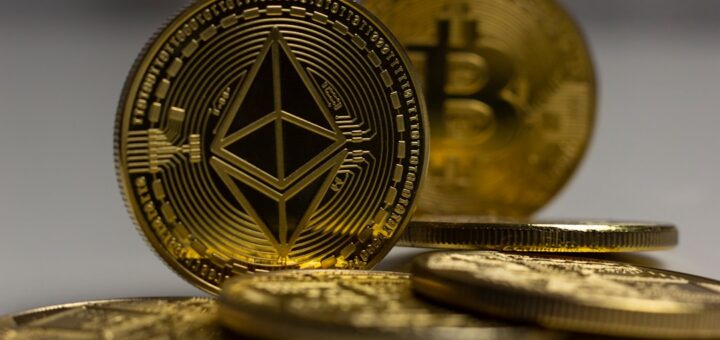 a pile of gold bitcoins sitting on top of a table
